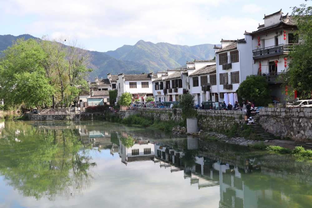 晴空之下，绿水青山宏村外河面倒影