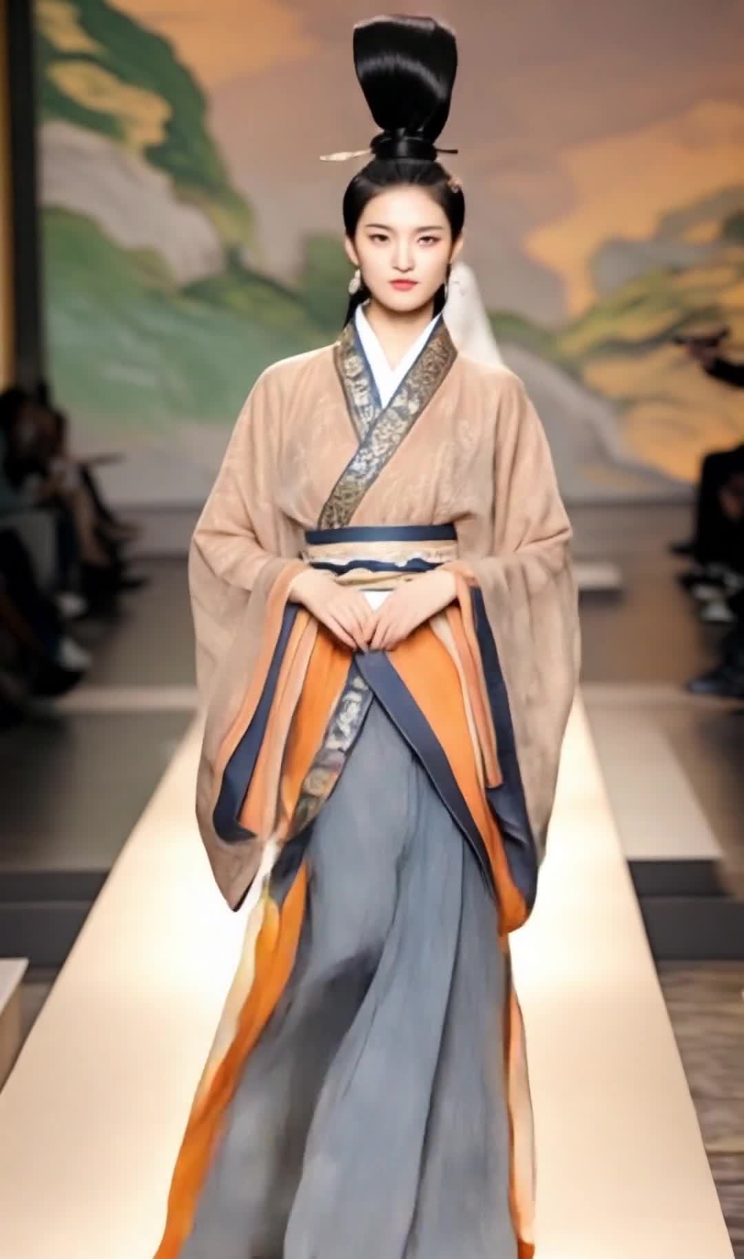 一名女子穿着汉服走在T台上，她梳着高发髻，佩戴耳环