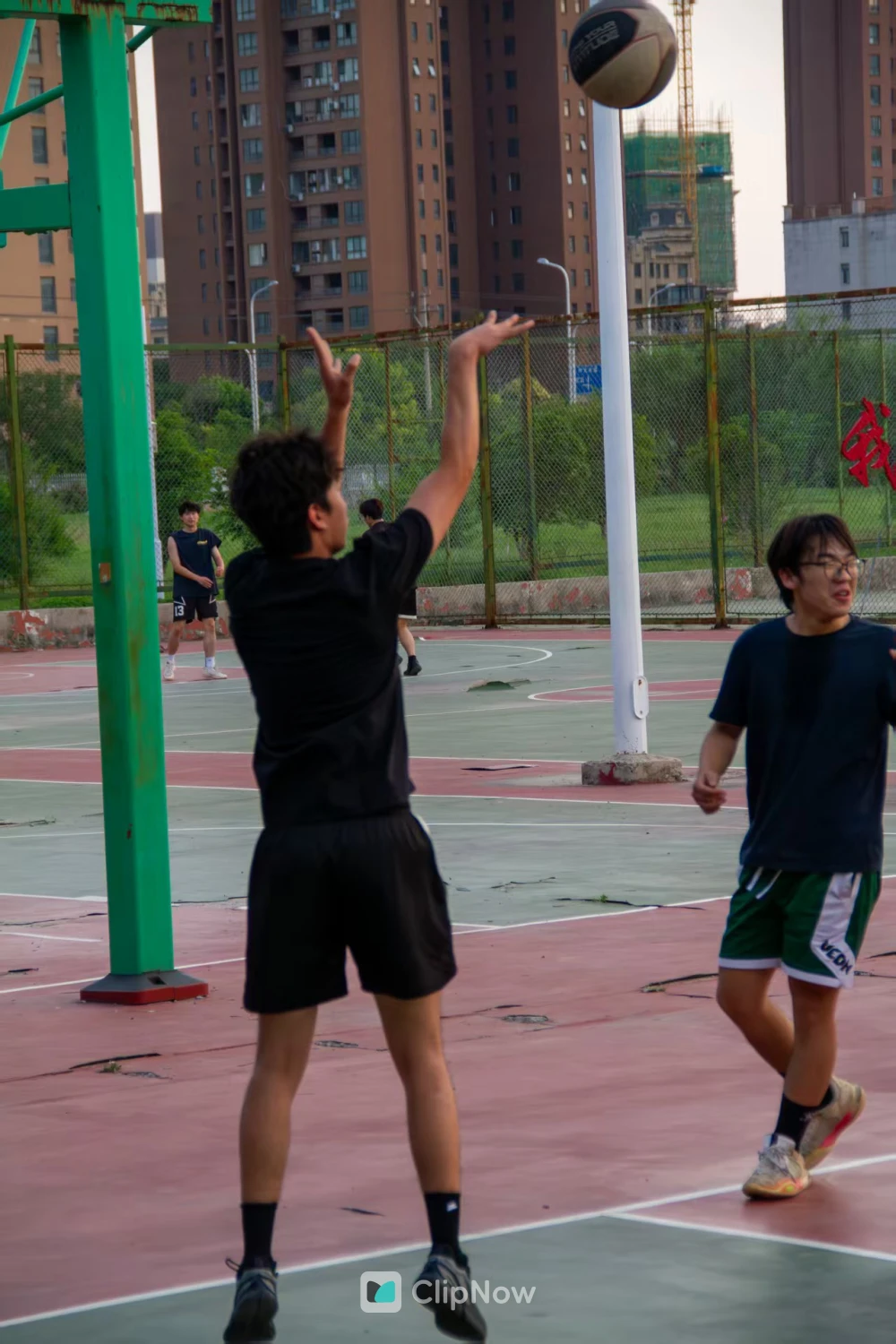 户外篮球场青年男子跳起投篮运动摄影