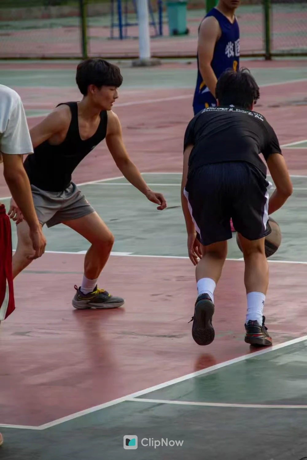 户外篮球场青年男子激烈对抗防守运球特写